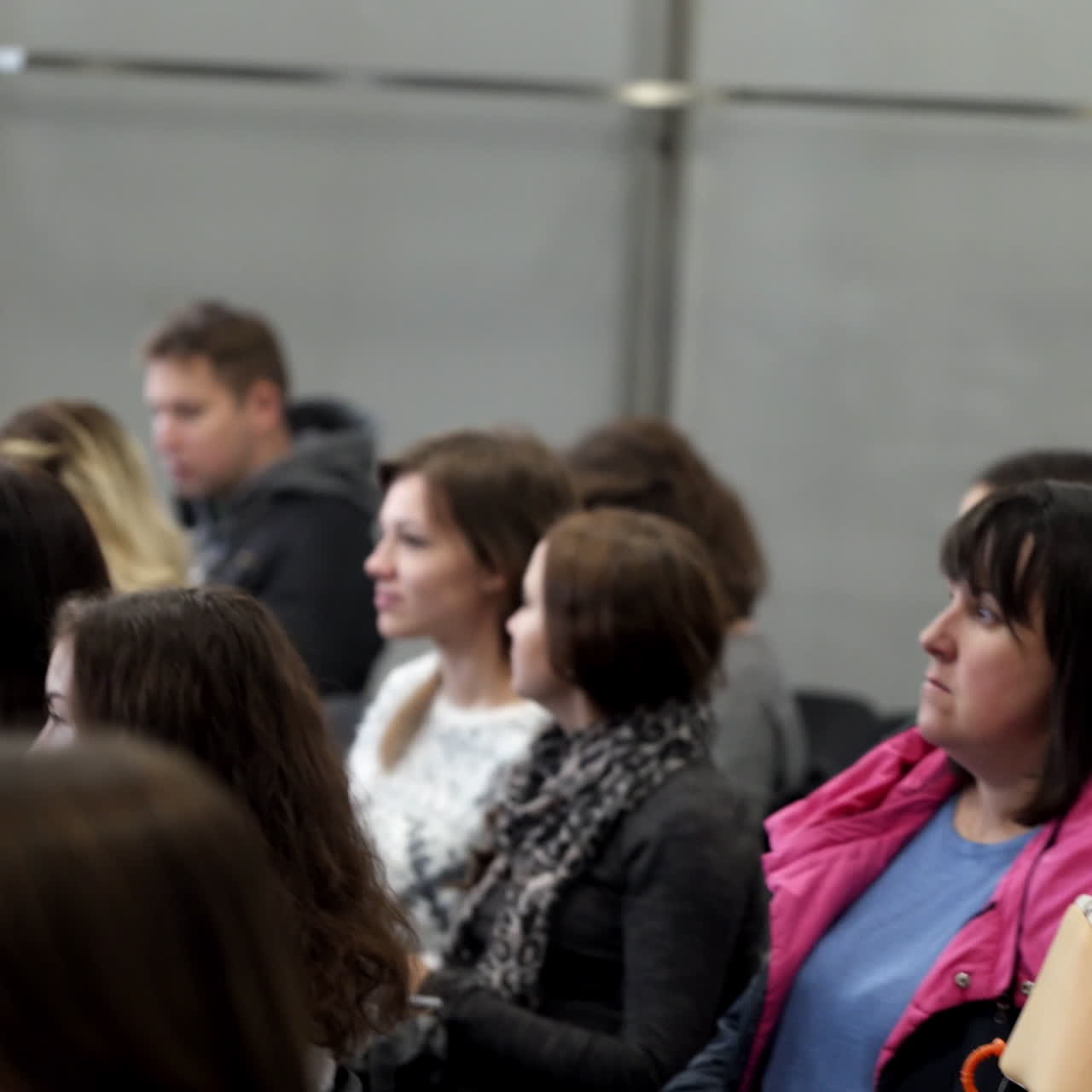 Spectators in the public seminar. People sitting in the conference hall and listening to speaker. Listeners are waiting for beginning of a lecture.