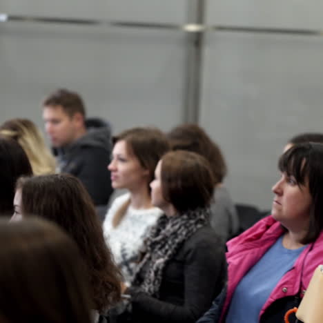 spectators in the public seminar. people sitting in the conference hall and listening to speaker. listeners are waiting for beginning of a lecture.