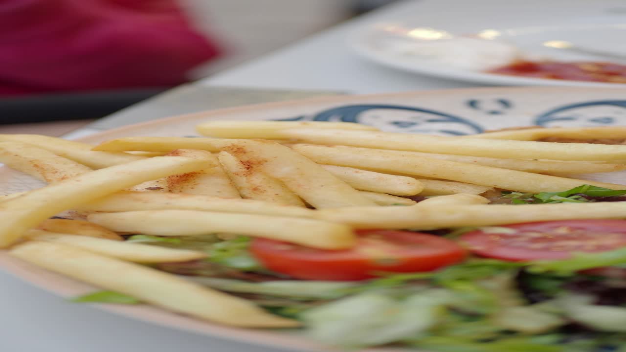 Closeup of French Fries, Tomatoes, and Lettuce on a Plate