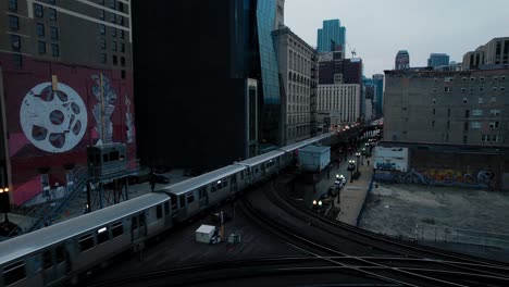 Fast-Moving-Commuter-Subway-Train-Passing-Through-City-Center-In-The-Evening