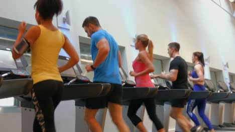 fit people running on treadmills