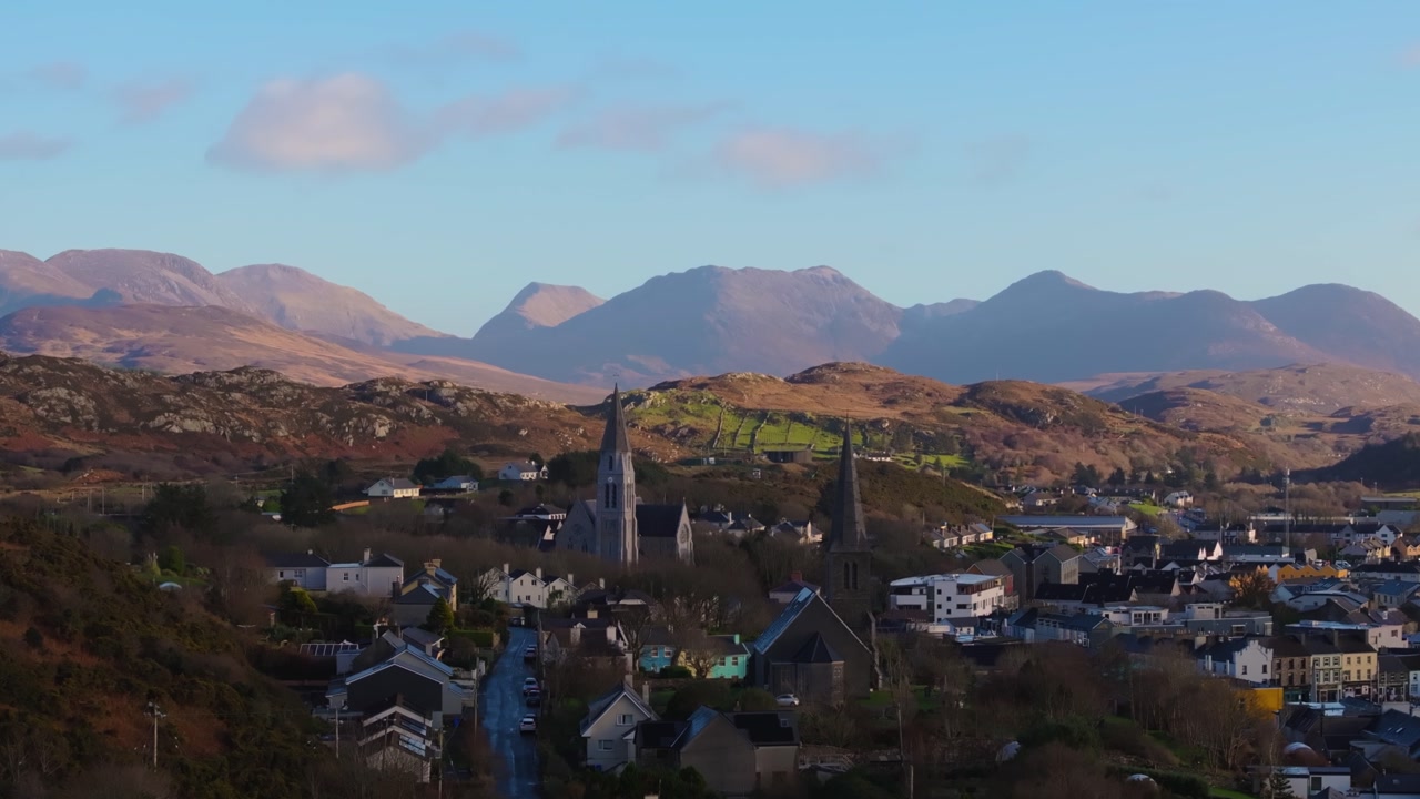 4K Aerial drone footage of St Joseph’s Church and Christ Church Clifden with Connemara Mountains Background_07