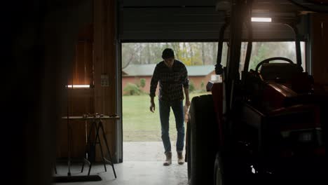 farmer in a garage with tractor