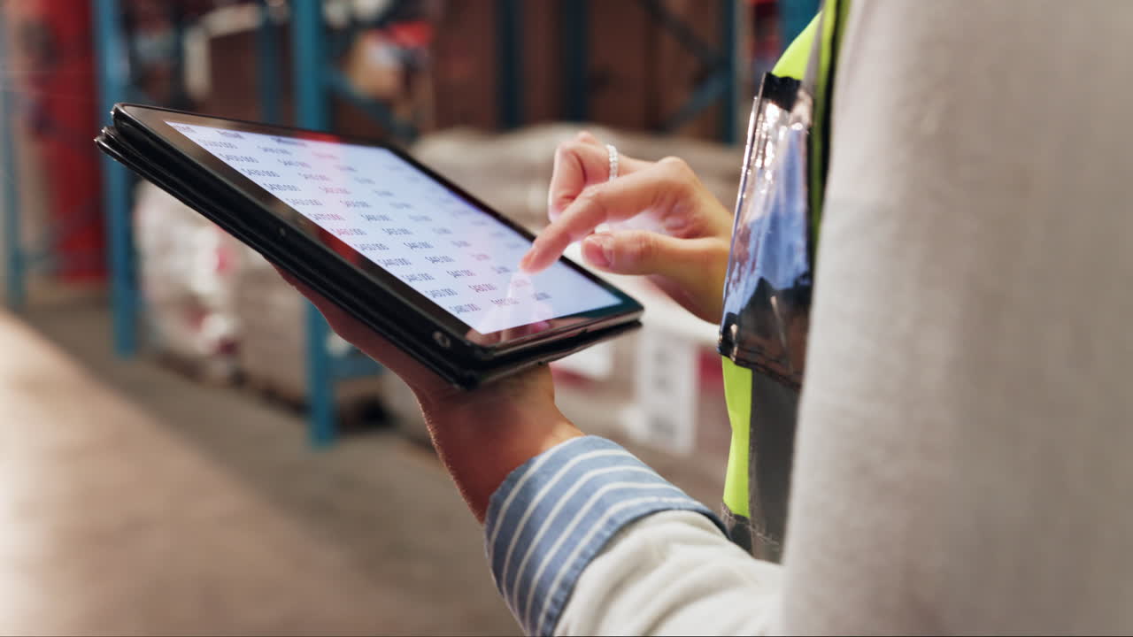 Woman Using Tablet in a Warehouse for Inventory Management