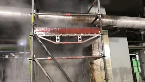 severe leak on a hot water pipe, water plunges on a jetty. steam and water in slow motion 120fps
