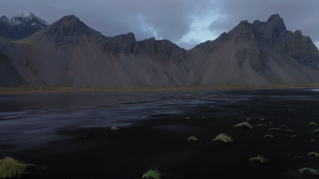 Aerial: Slow panning shot of Vestrahorn at Stokksnes peninsula during dusk