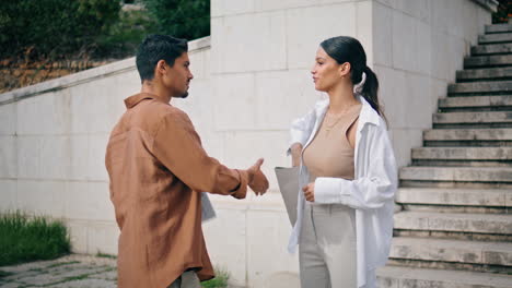 confident lady calling phone at staircase place closeup. partners handshaking