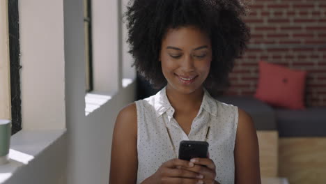 happy young woman using smartphone at home browsing social media messages enjoying relaxed lifestyle african american female texting on mobile phone