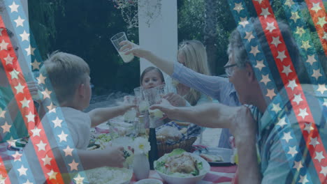 animation of stripes with stars over happy caucasian family eating in garden