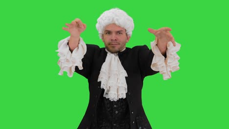 man dressed like mozart conducting expressively while looking at camera on a green screen, chroma key