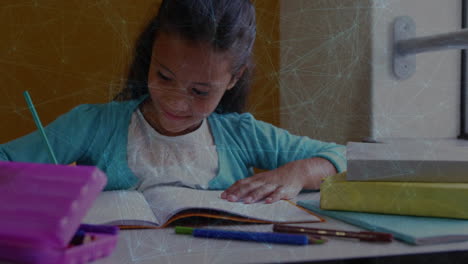 student girl writing in notebook at desk, showing colored pencils and network overlay for education
