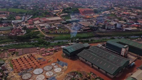 high angle view of smoke coming from factory chimneys of a large production company in ibadan, nigeria, africa