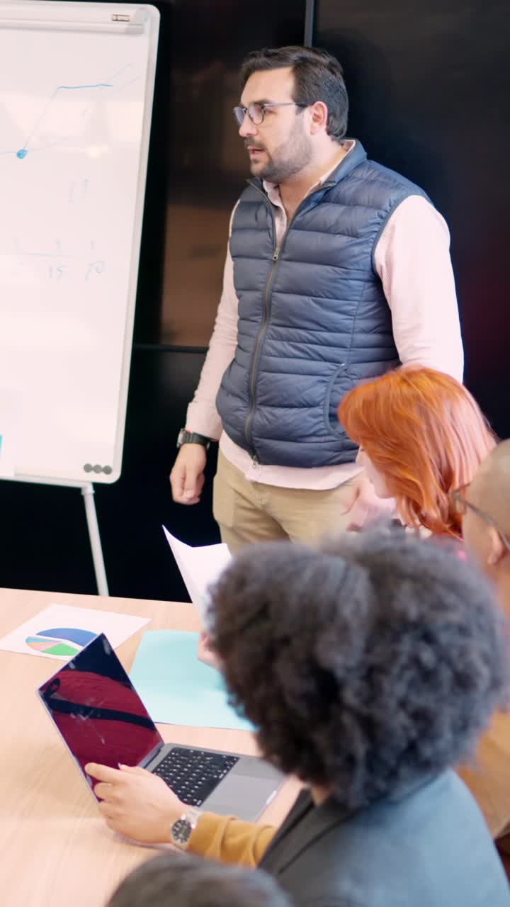 Worker explaining a project to colleagues in a meeting room