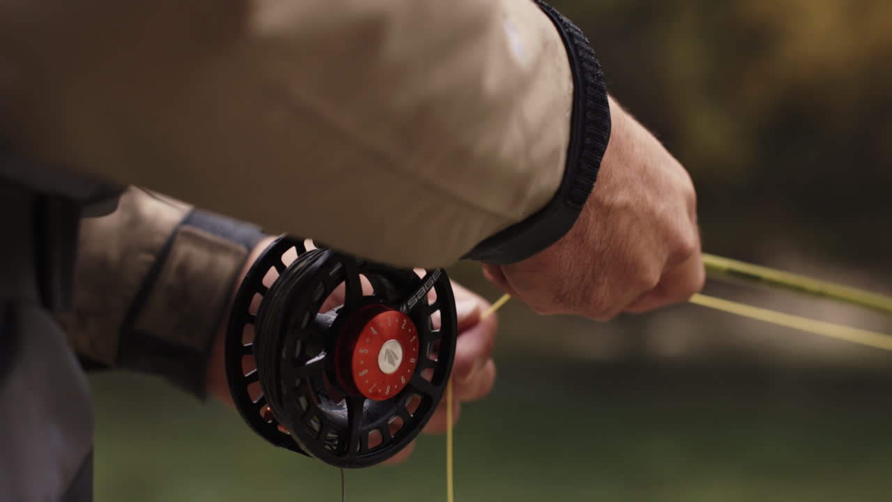 Fly Fisherman Adjusting Fishing Line