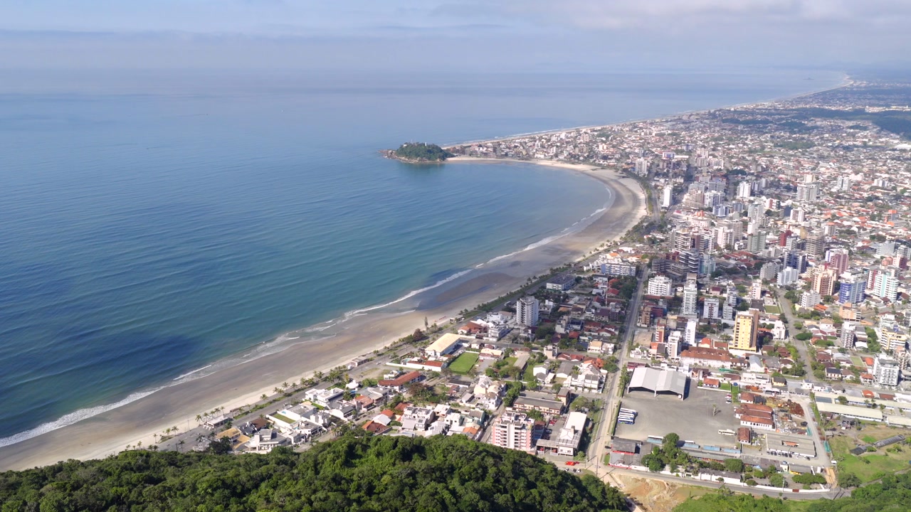 Aerial view of Guaratuba city with coastal skyline, sandy beach, and ocean bay, Paraná, Brazil.