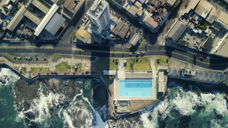 drone-shot-of-the-beach,-mountains,-and-city-skyscrapers-of-Iquique,-Chile-South-America