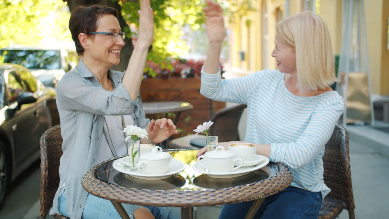 Two Women Enjoying Coffee in a Cafe