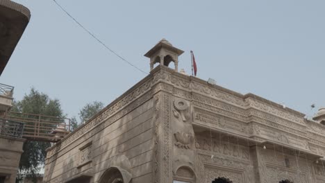 ancient-hindu-temple-made-of-red-stone-at-day-from-different-angle-video-is-taken-at-pal-balaji-temple-jodhpur-rajasthan-india-On-Nov-13-2023