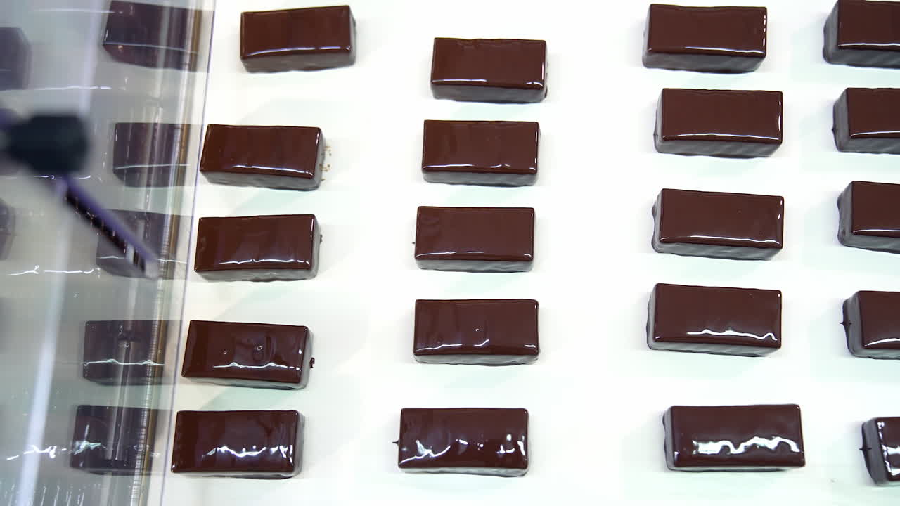 Moving conveyor with chocolate delicious candies. Production delicious factory line.