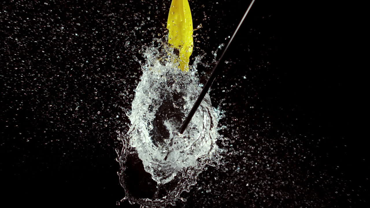 Arrow bursting a water balloon