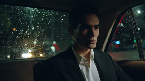 car passenger resting vehicle at evening closeup. model guy looking rain window
