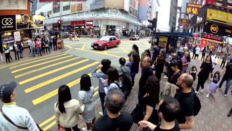 tourism crowds walking across the street in asia shopping street