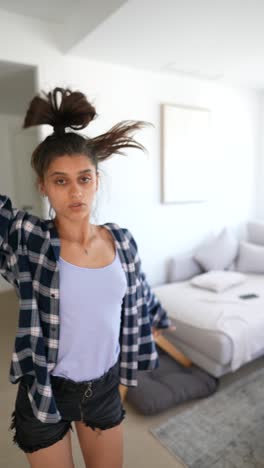 young woman dancing in living room