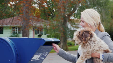 A-Woman-With-A-Dog-Mails-A-Letter