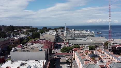 close-up aerial shot flying over historic cannery row in monterey, california