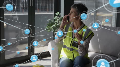 Animation-of-network-of-connections-with-icons-over-female-engineer-using-smartphone