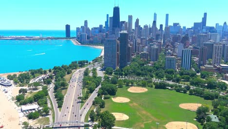 aerial fly by of lake michigan with downtown chicago skyline in the background | high noon lighting