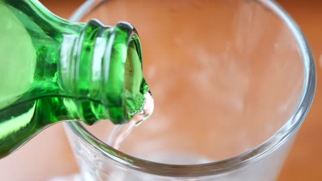 pouring drink into a glass