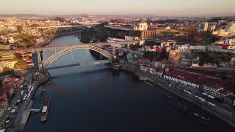 Stunning-sunset-Drone-shots-of-the-Douro-River-in-the-heart-of-Porto,-Portugal