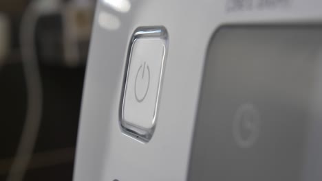 pressing stand by power button to turn on and off the device close-up