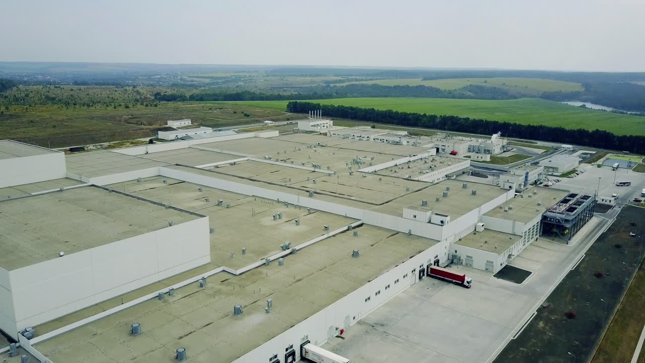 Modern Exterior Of Industrial Building. Gray facade made of aluminum panels with doors and windows on industrial building
