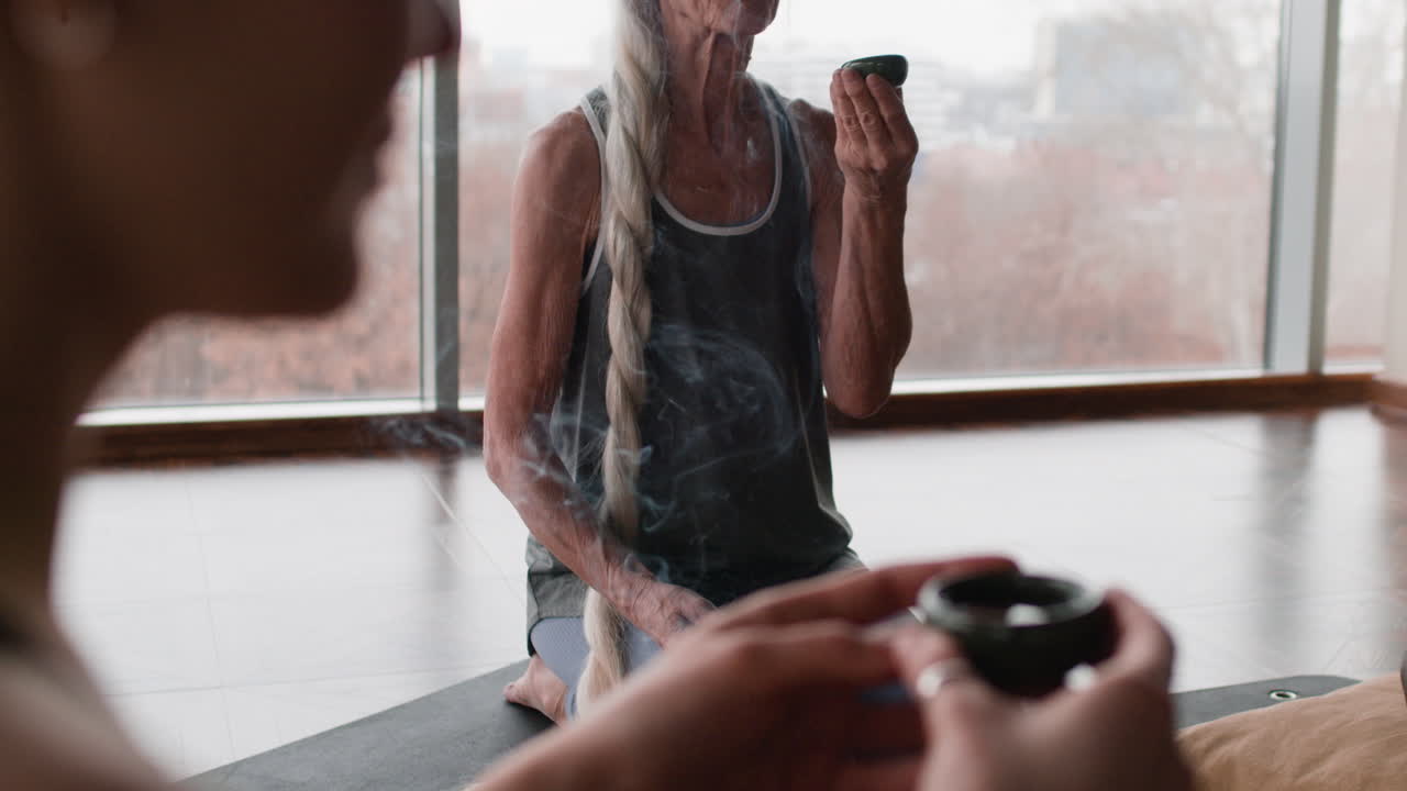 Senior Woman in Yoga Class Enjoying a Tea Ceremony