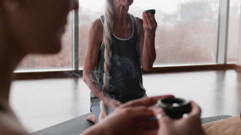 Senior Woman in Yoga Class Enjoying a Tea Ceremony