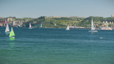 tagus river in lisbon with sailboats on sight long shot