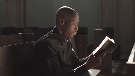 Priest Sitting in Lutheran Church and Reading