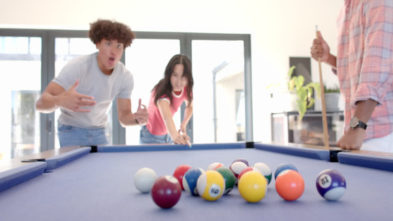 At home, Playing pool, diverse friends enjoying fun hangout, focusing on billiard balls