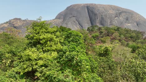 Aerial---Descending-wide-shot-of-a-Aso-rock-in-a-national-park