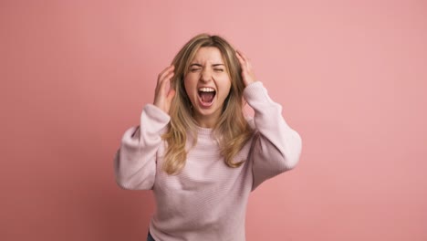 desperate woman yelling with eyes closed and hands on head