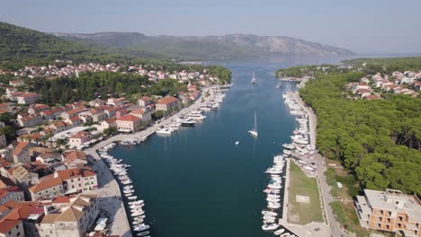 Aerial-croatia:-Stari-Grad,-Hvar---harbor-with-moored-boats-and-coastal-town-backdrop