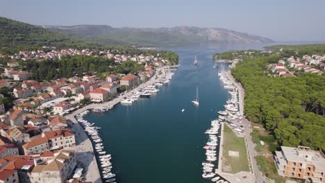 aerial croatia: stari grad, hvar - harbor with moored boats and coastal town backdrop