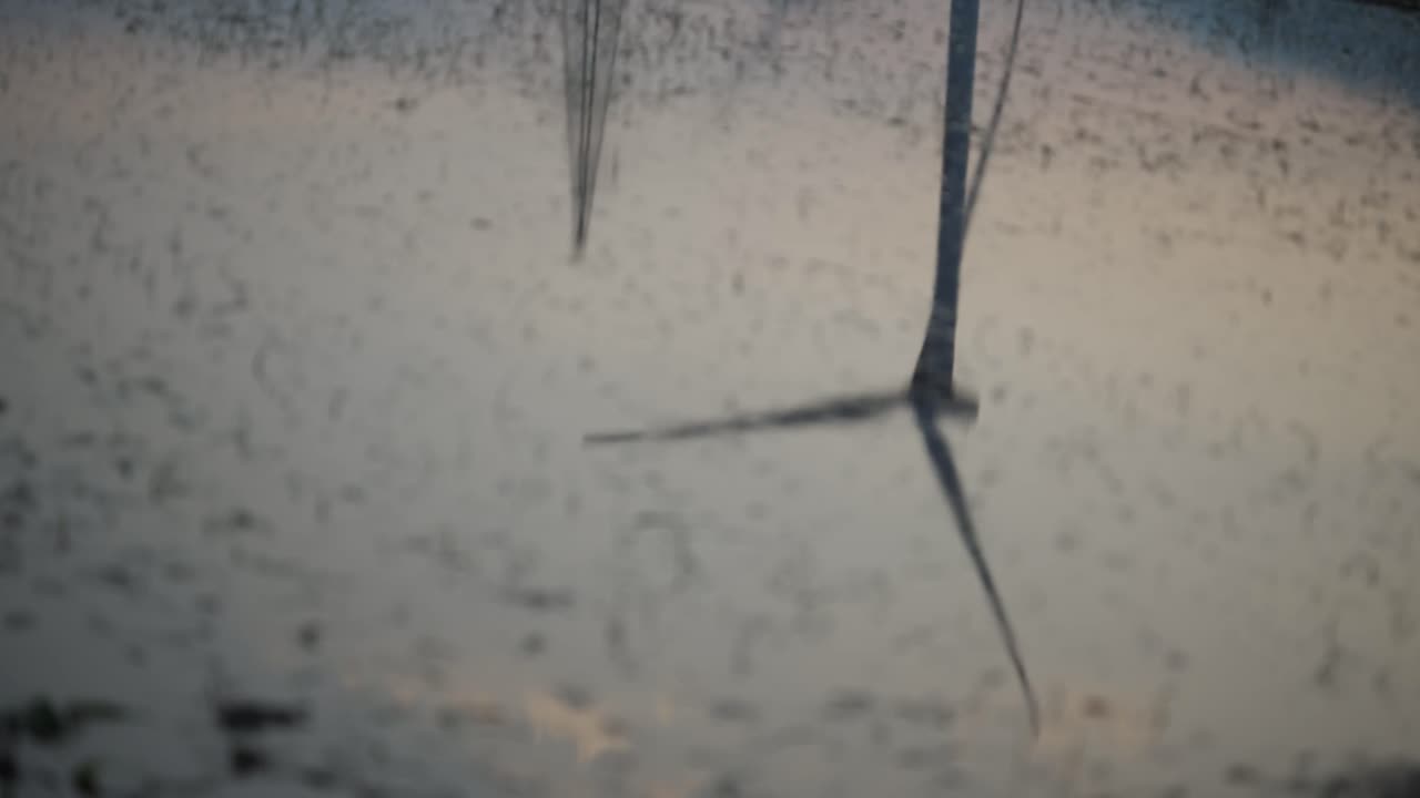 Refelcetion of a wind turbine in a Chinese farm located in the valley of Sichuan located in between traditional chinese farms