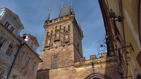 looking up at the mala strana bridge tower, prague, czechia, blue sky, dolly in