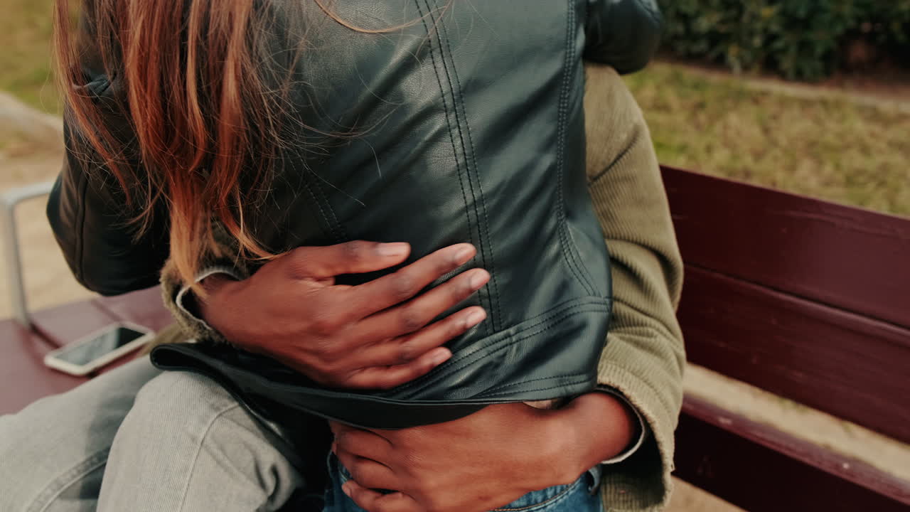 Affectionate Couple Hugging on a Park Bench