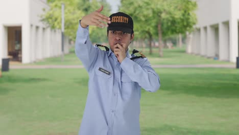 indian security guard calling someone by using whistle