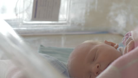 a newborn girl moving in her sleep