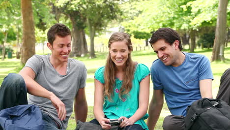 Three-friends-posing-as-they-take-a-photo-of-themselves-before-laughing